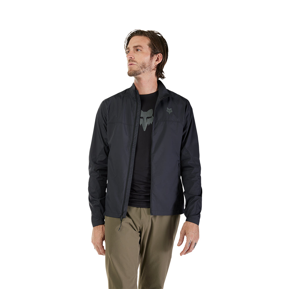 Man wearing a black jacket with a brand logo on a white background