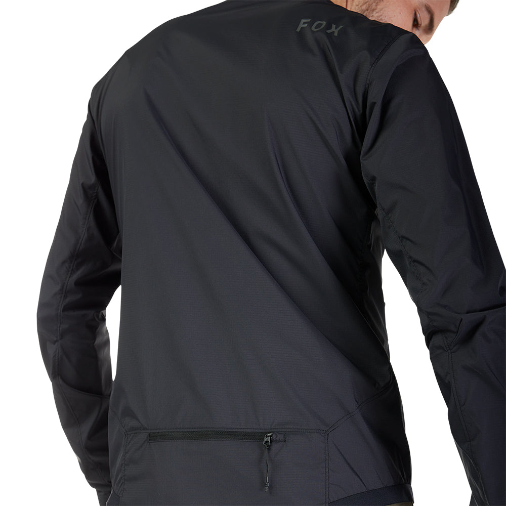 Black jacket with 'FOX' branding on the back, worn by a person.