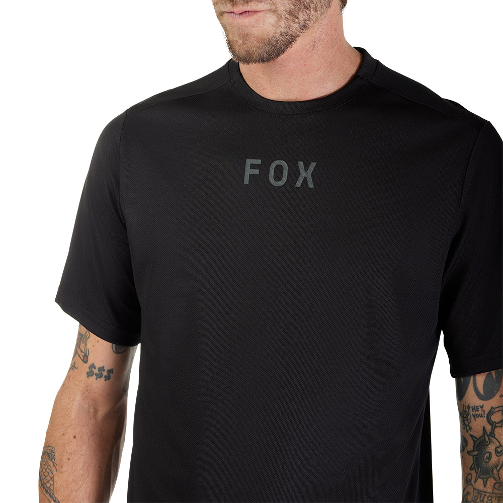 Person wearing a black t-shirt with 'FOX' logo on a white background