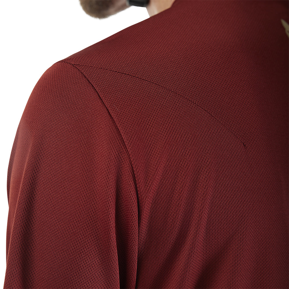 Close-up of a textured red garment on a white background