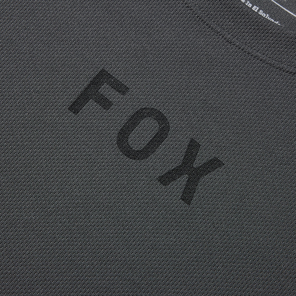 Close-up of a dark gray fabric with 'FOX' embroidered in black.