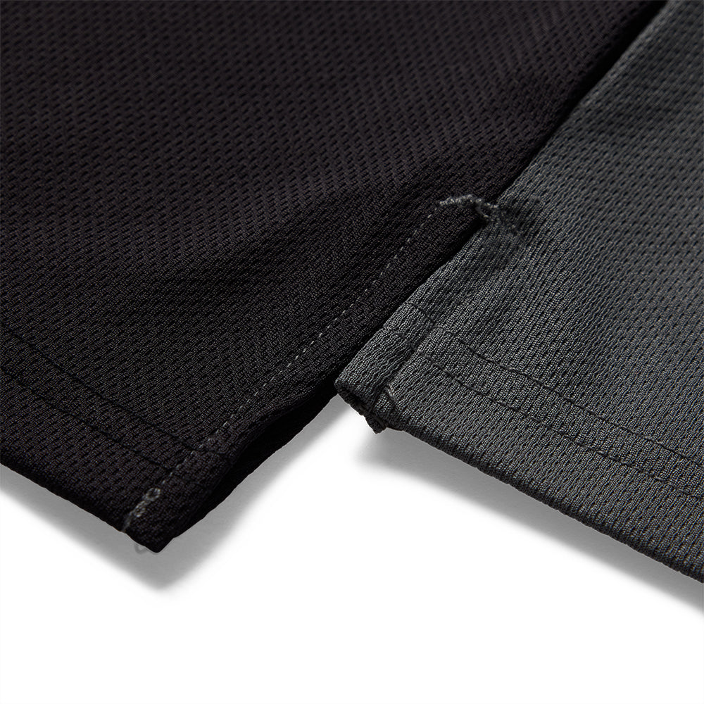 Close-up of black fabric with a visible seam on a white background