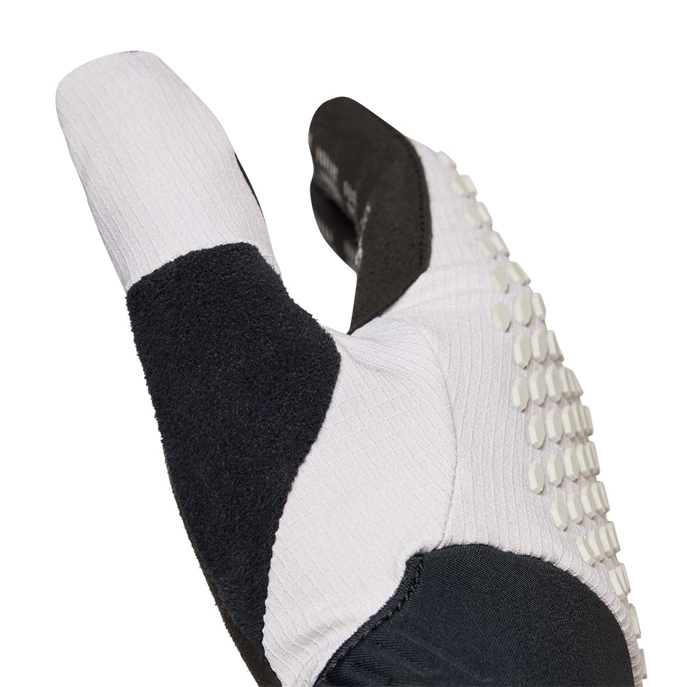 Close-up of a black and white glove with textured sole on a white background