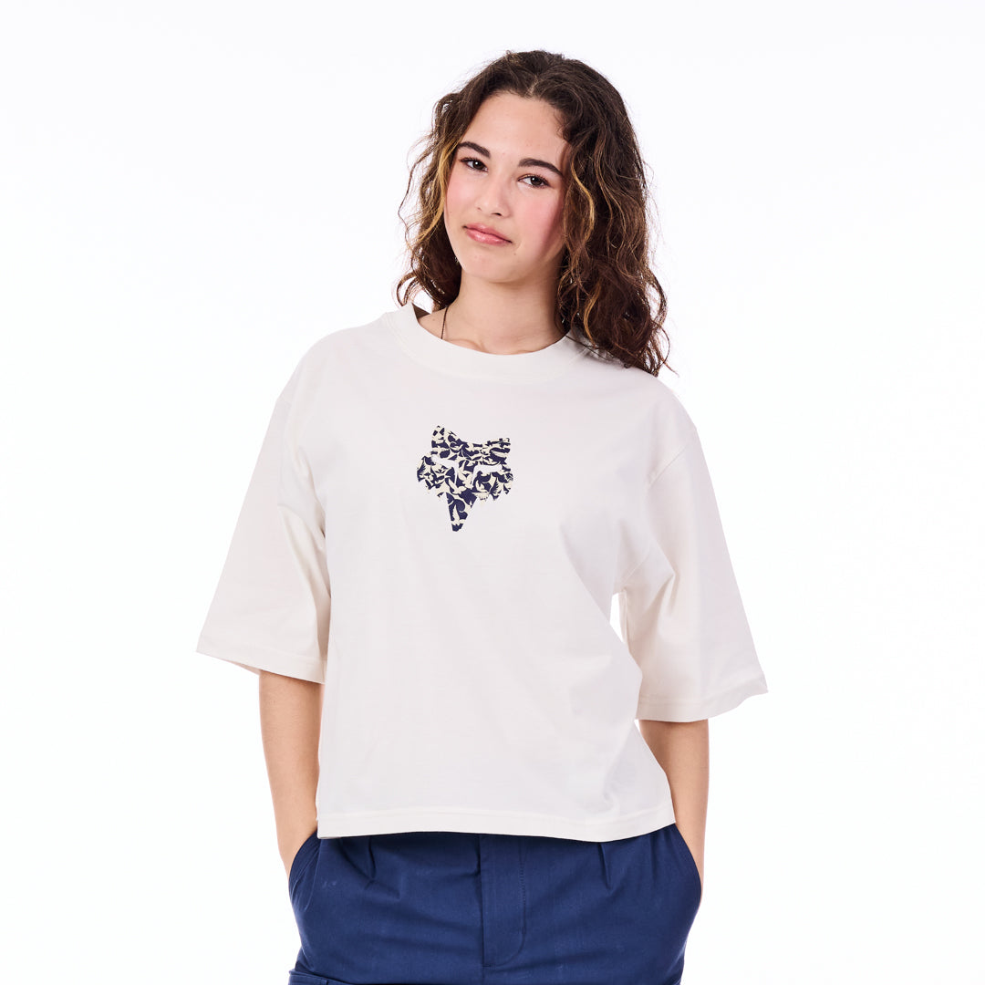 Person wearing a white t-shirt with a black floral design on a white background