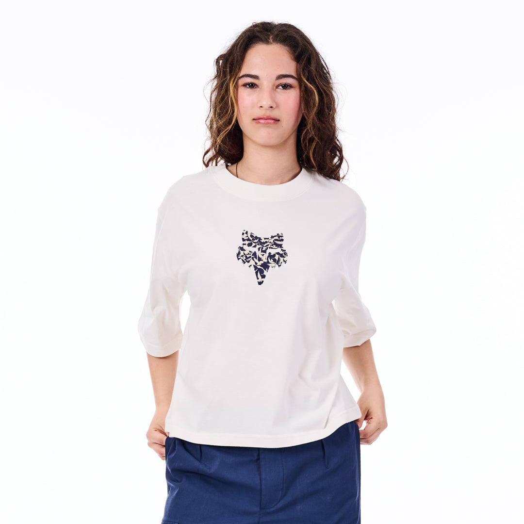 Woman wearing a white shirt with a black design on a white background