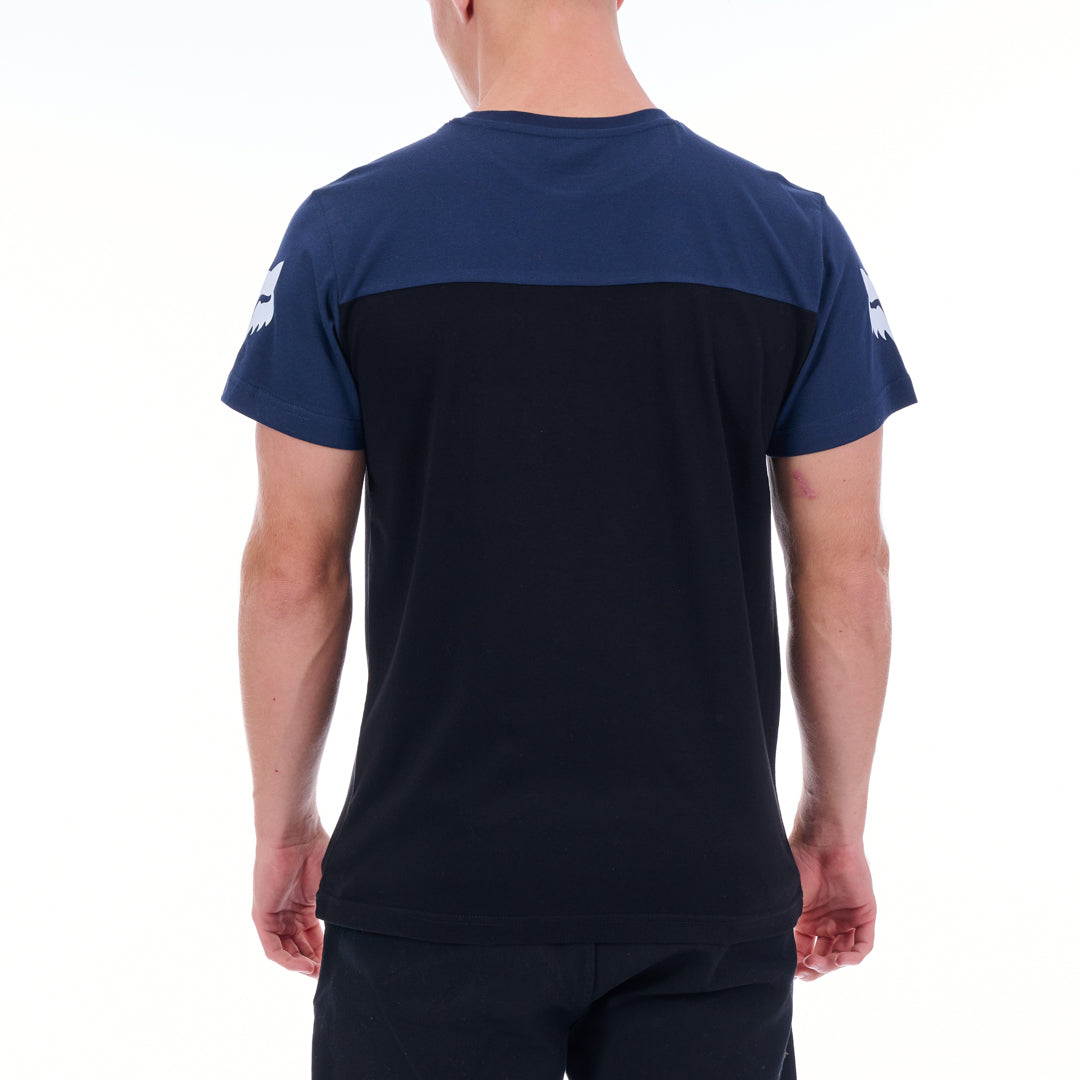 Person wearing a navy blue t-shirt with a black panel on a white background