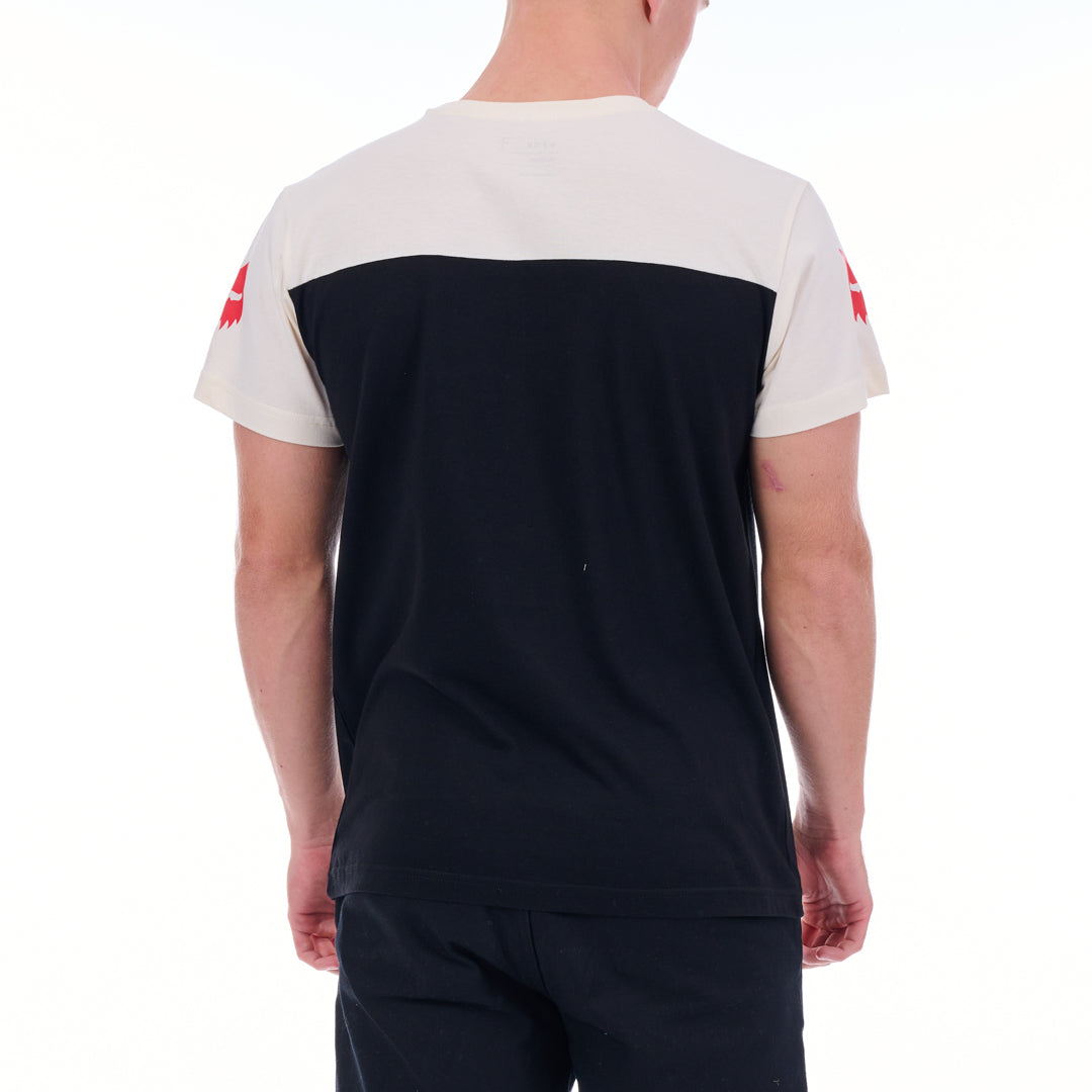Person wearing a black and white t-shirt with red logos on a white background