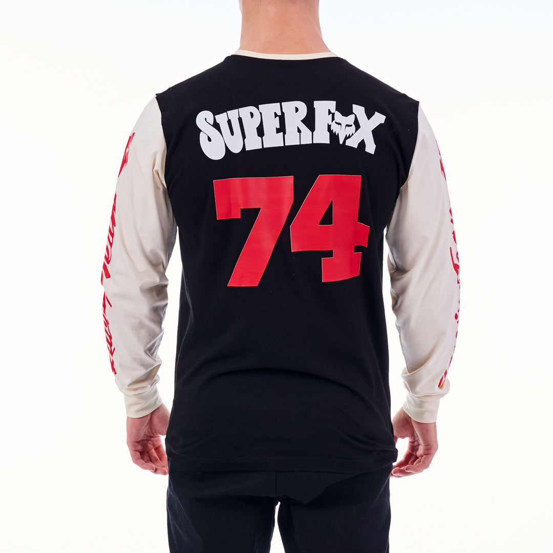Black and white long-sleeve shirt with red number 74 and 'Super' text on the back, worn by a person.