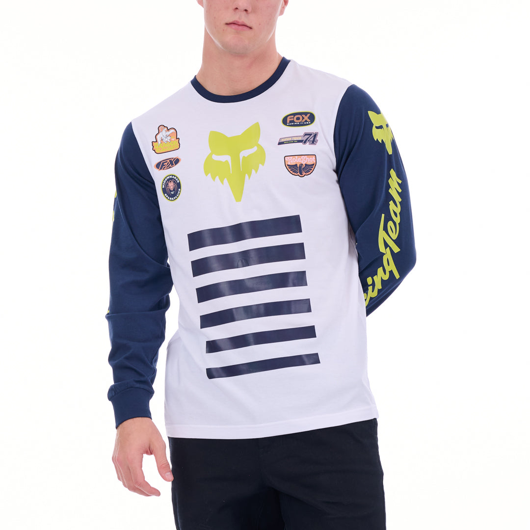 Person wearing a white and blue long-sleeve shirt with various logos on a white background