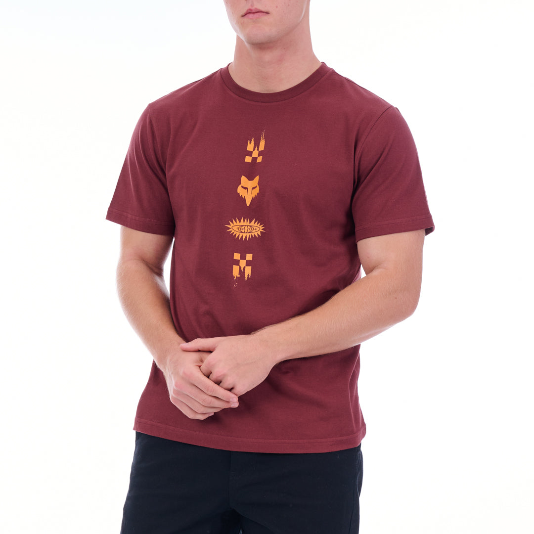 Maroon t-shirt with orange graphics worn by a person on a white background