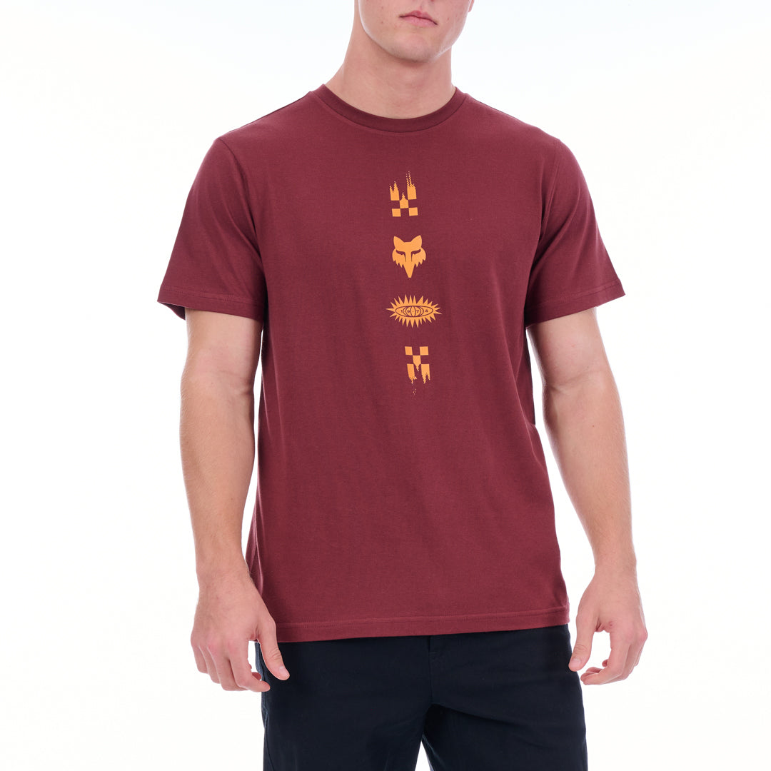 Maroon t-shirt with yellow graphics worn by a person on a white background