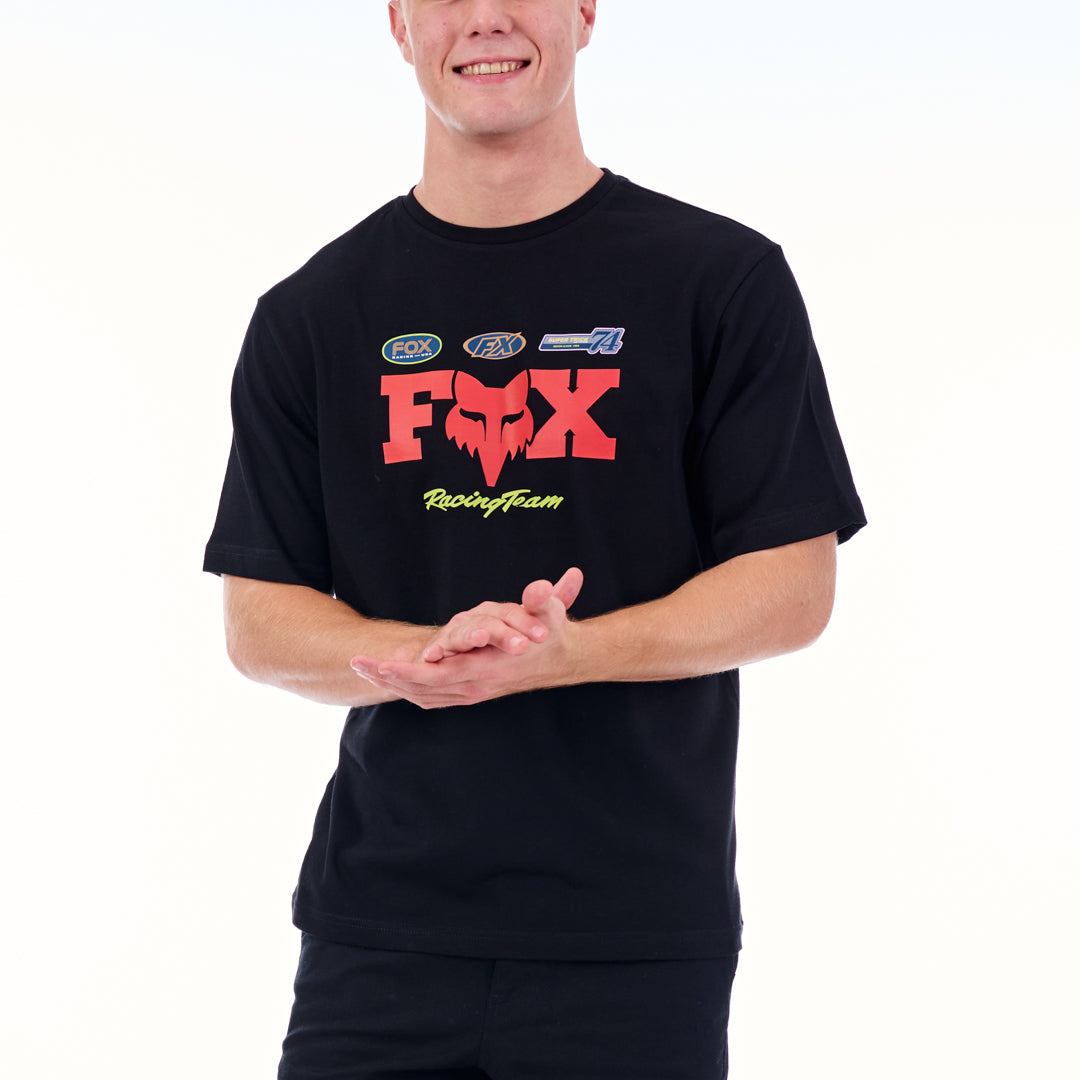 Person wearing a black t-shirt with red and yellow graphics on a white background