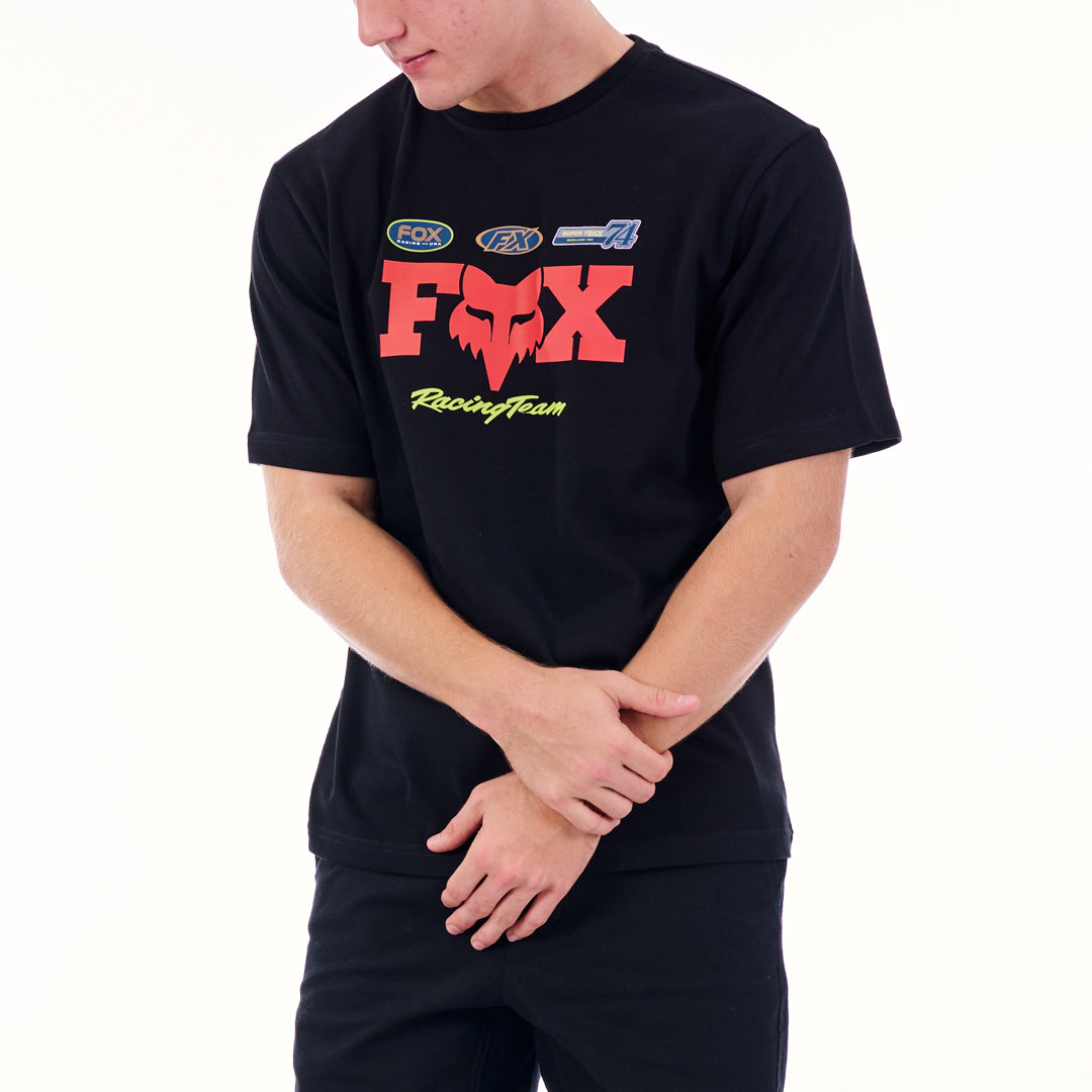 Person wearing a black t-shirt with a red and yellow 'Fox Racing Team' logo on a white background
