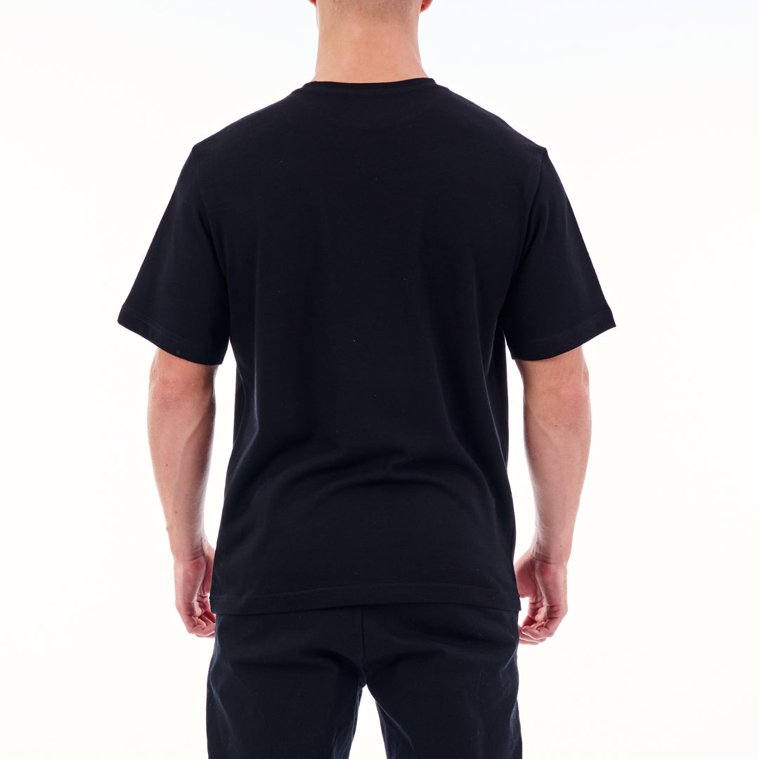 Person wearing a black t-shirt and pants on a white background