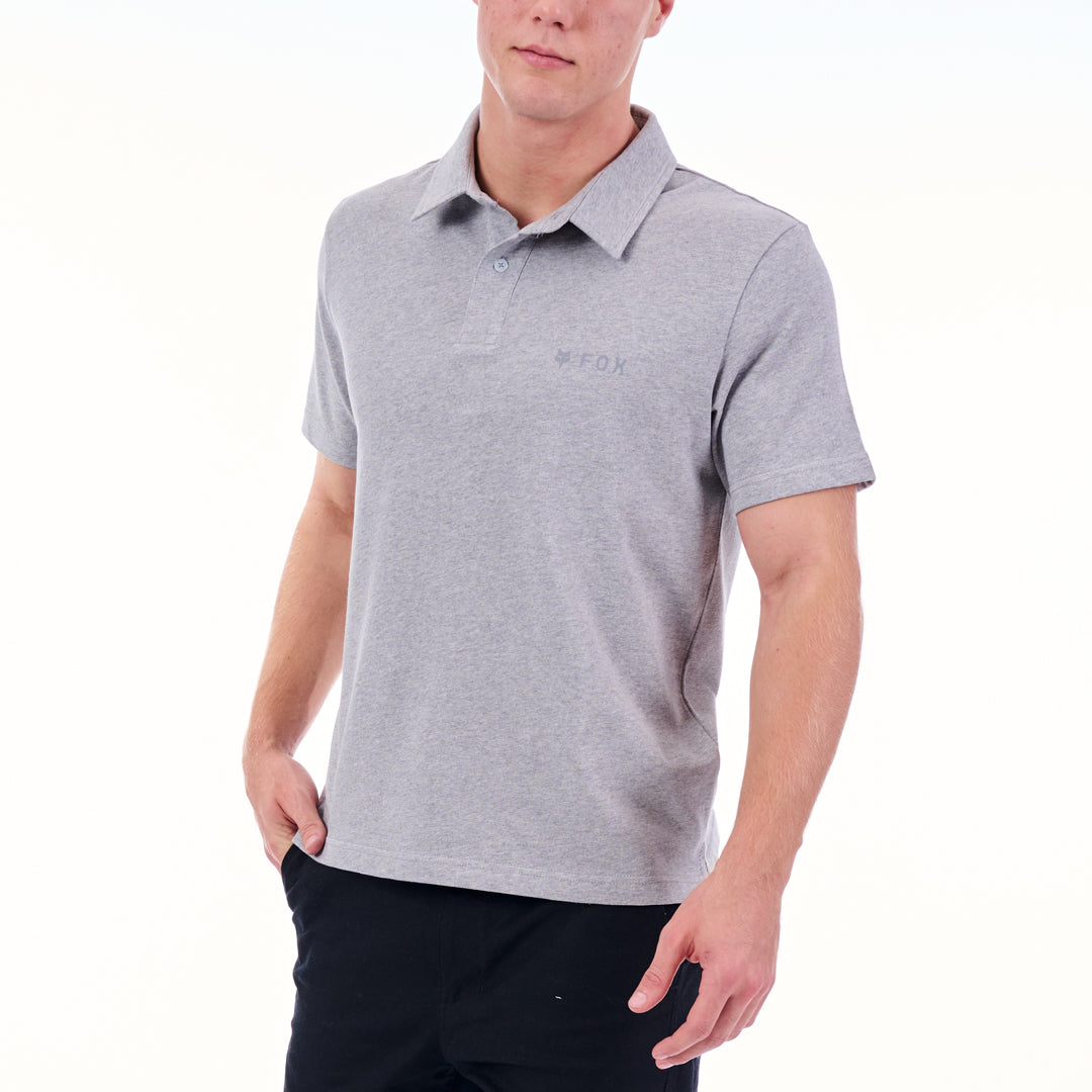 Person wearing a gray polo shirt with a brand logo on a white background