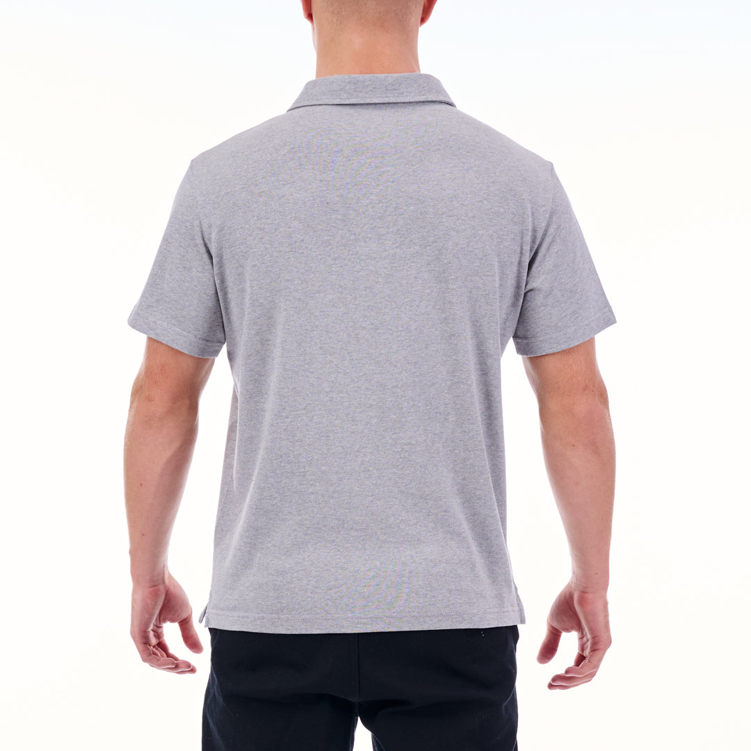 Person wearing a gray polo shirt on a white background