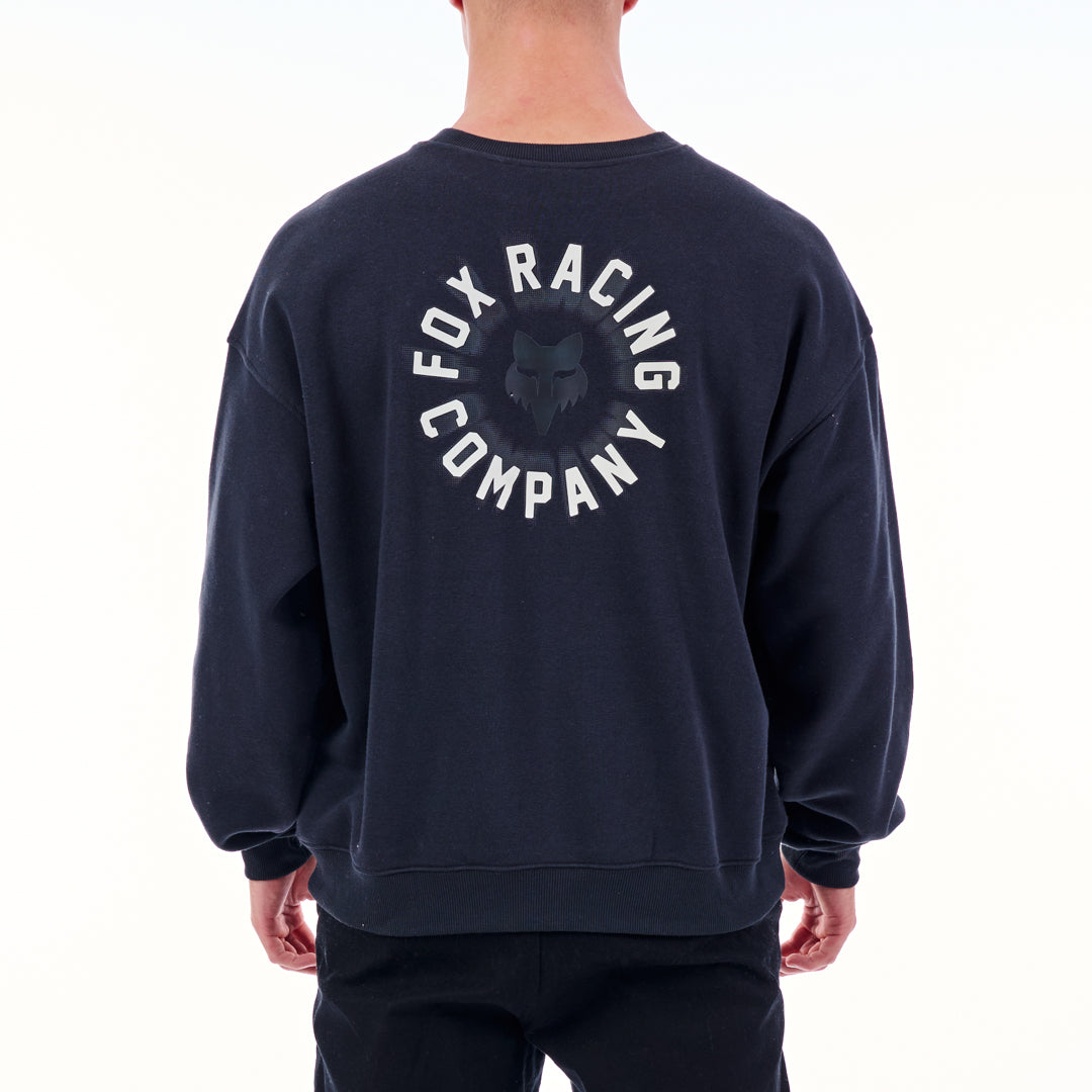 Navy sweatshirt with 'Fox Racing Company' logo on the back, worn by a person.