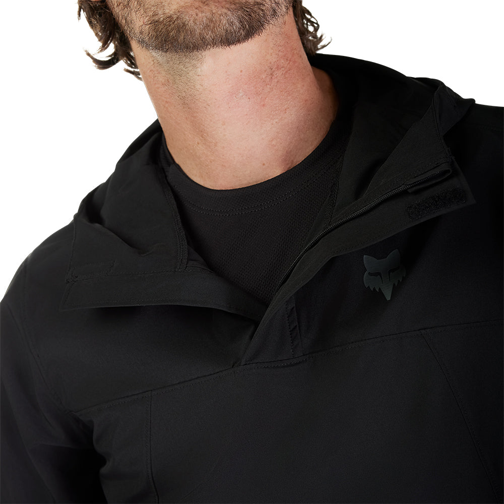 Close-up of a person wearing a black jacket with a hood on a white background