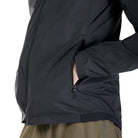 Close-up of a person wearing a black jacket with a white background