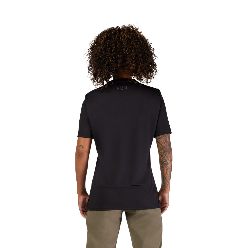 Person wearing a black t-shirt with 'FOX' branding on the back, standing against a white background.