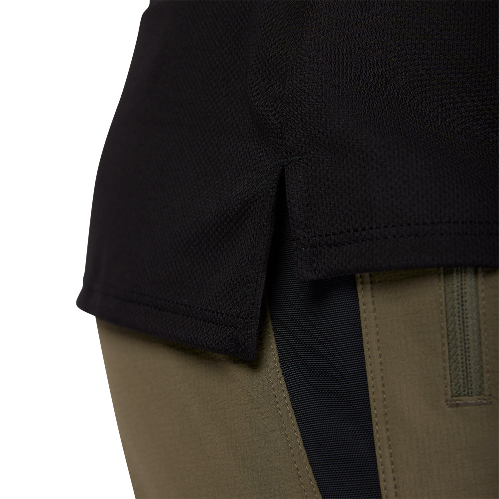 Close-up of a black sleeve and khaki pants with a visible brand logo.