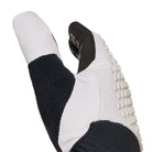 Close-up of a black and white glove with textured sole on a white background