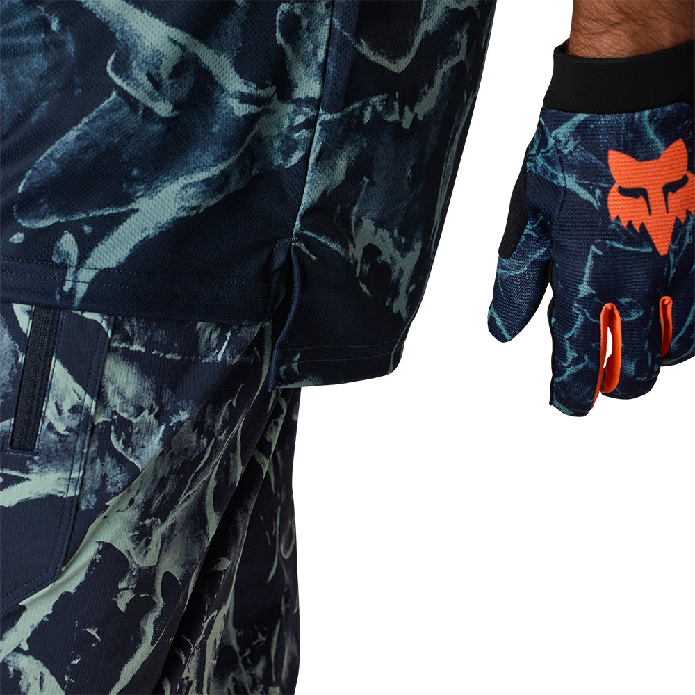Camouflage pants and glove with orange logo on a white background