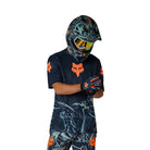 Person wearing a full motocross outfit with helmet, shirt, and pants on a white background