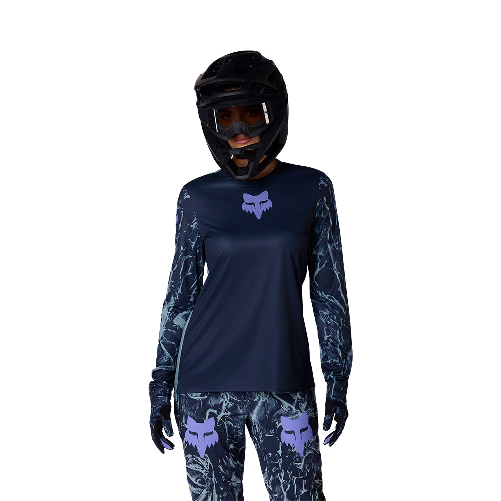 Person wearing a navy blue motocross outfit with fox logo on a white background
