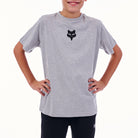 Child wearing a gray t-shirt with a black logo on a white background