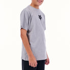 Person wearing a gray t-shirt with a black logo on a white background
