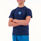 Person wearing a navy blue t-shirt with a blue fox logo on a white background