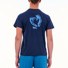 Person wearing a navy blue t-shirt with a dolphin graphic on the back, on a white background