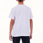 Person wearing a plain white t-shirt on a white background
