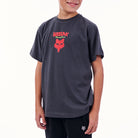 Child wearing a dark gray t-shirt with a red and white logo on a white background
