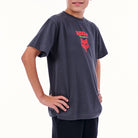 Child wearing a dark gray t-shirt with a red logo on a white background