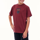 Child wearing a maroon t-shirt with a logo on a white background
