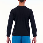 Person wearing a black long-sleeve shirt and blue pants on a white background