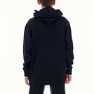 Black hoodie worn by a person on a white background