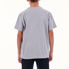 Person wearing a gray t-shirt on a white background