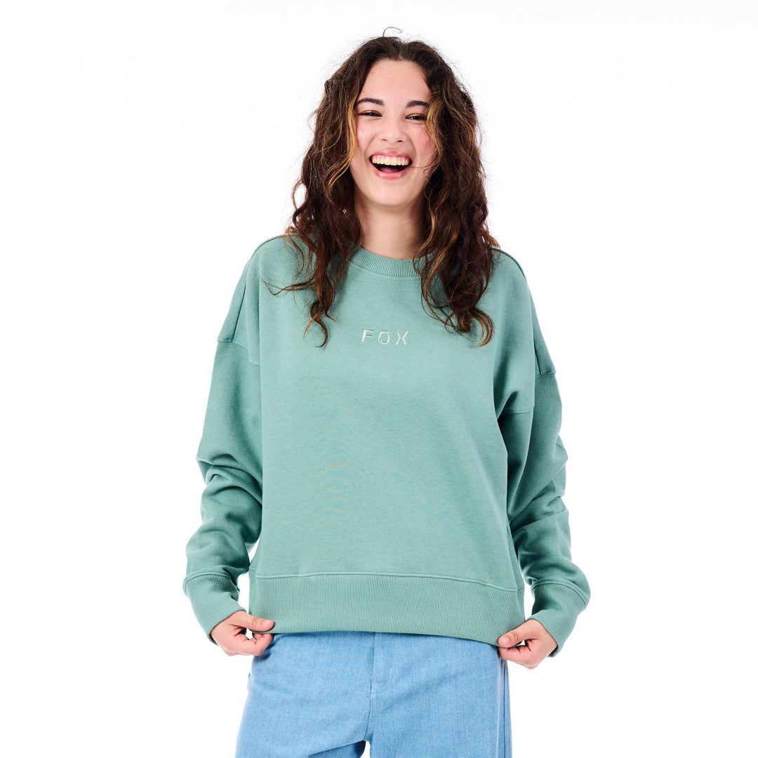 Person wearing a green sweatshirt with 'FOX' logo on a white background