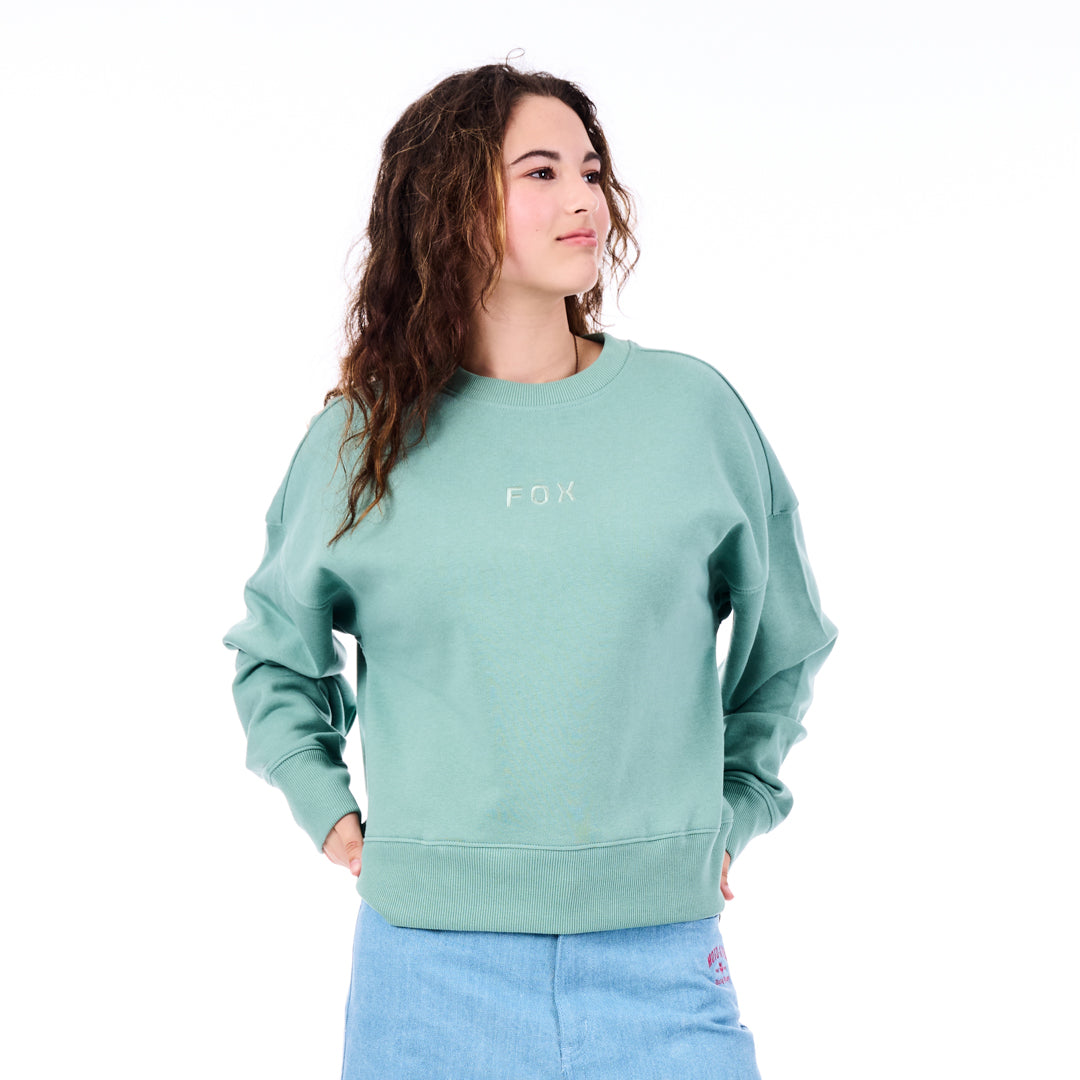 Person wearing a light green sweatshirt with 'FOX' logo on a white background