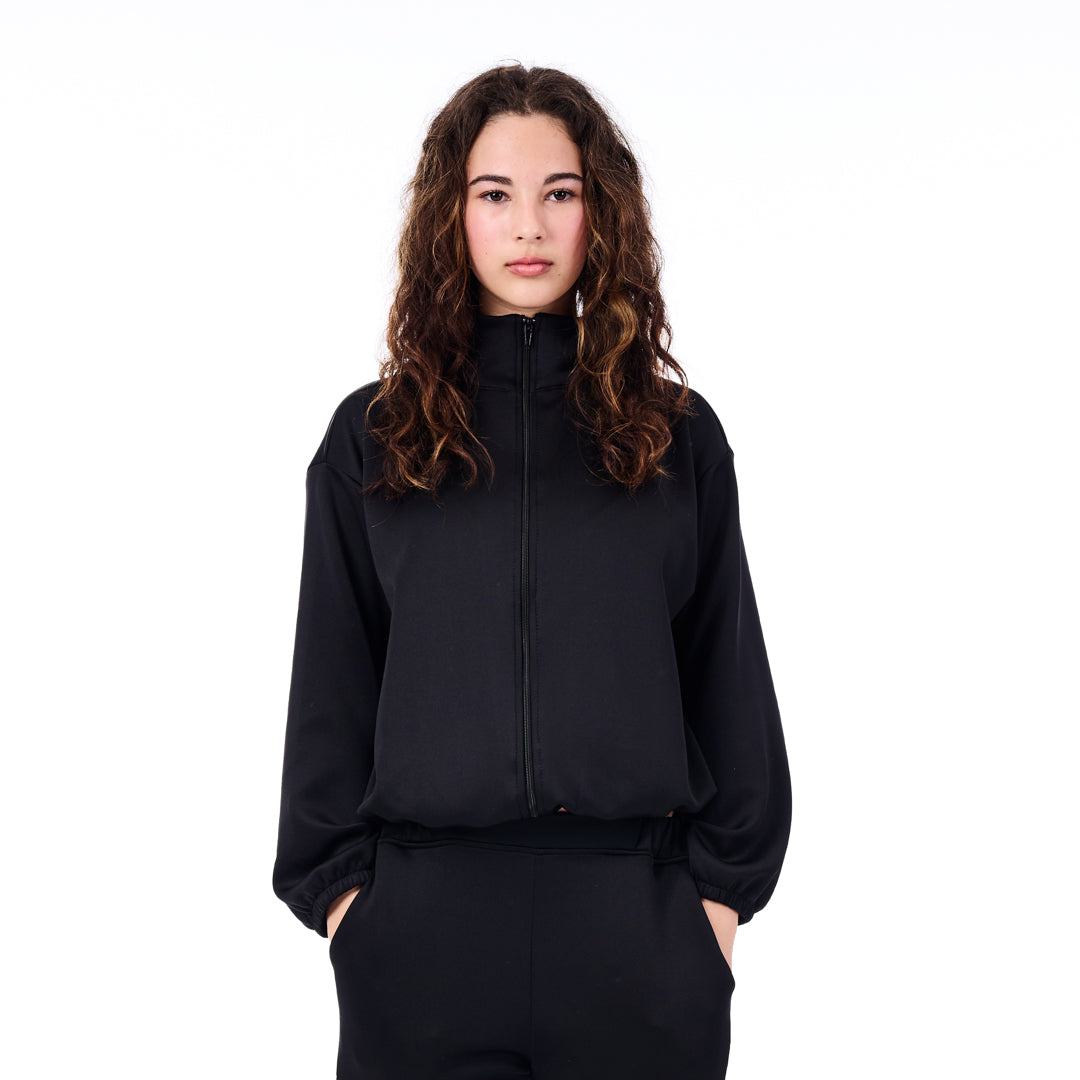 Person wearing a black tracksuit on a white background