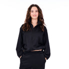 Person wearing a black outfit on a white background