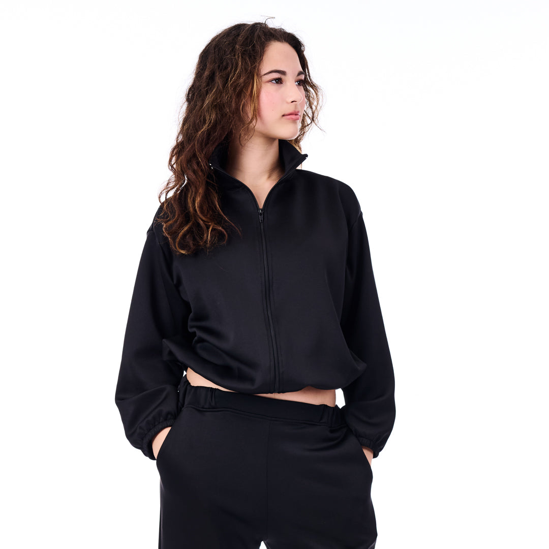 Person wearing a black tracksuit on a white background