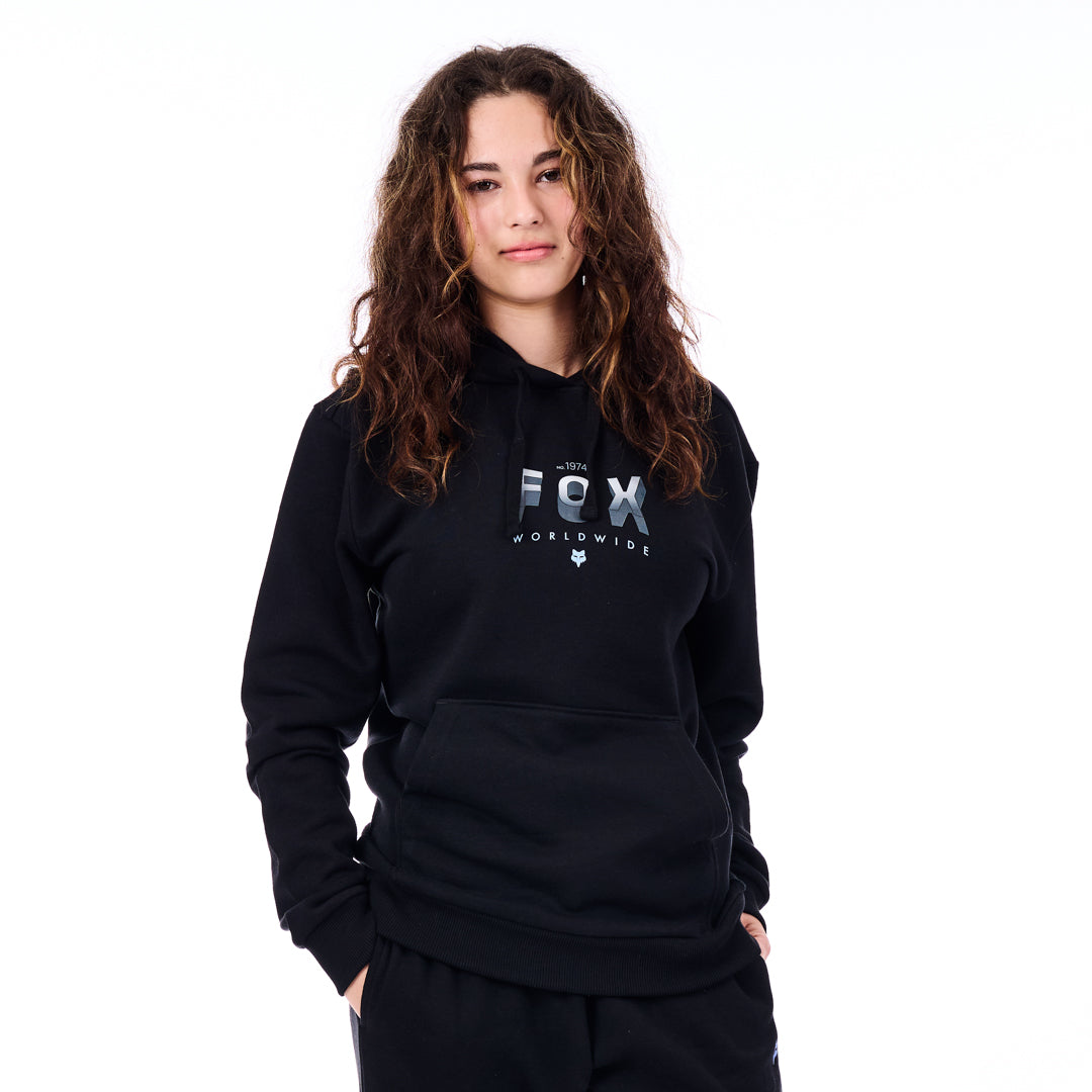 Person wearing a black hoodie with 'FX' logo on a white background