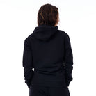 Person wearing a black hoodie from behind on a white background