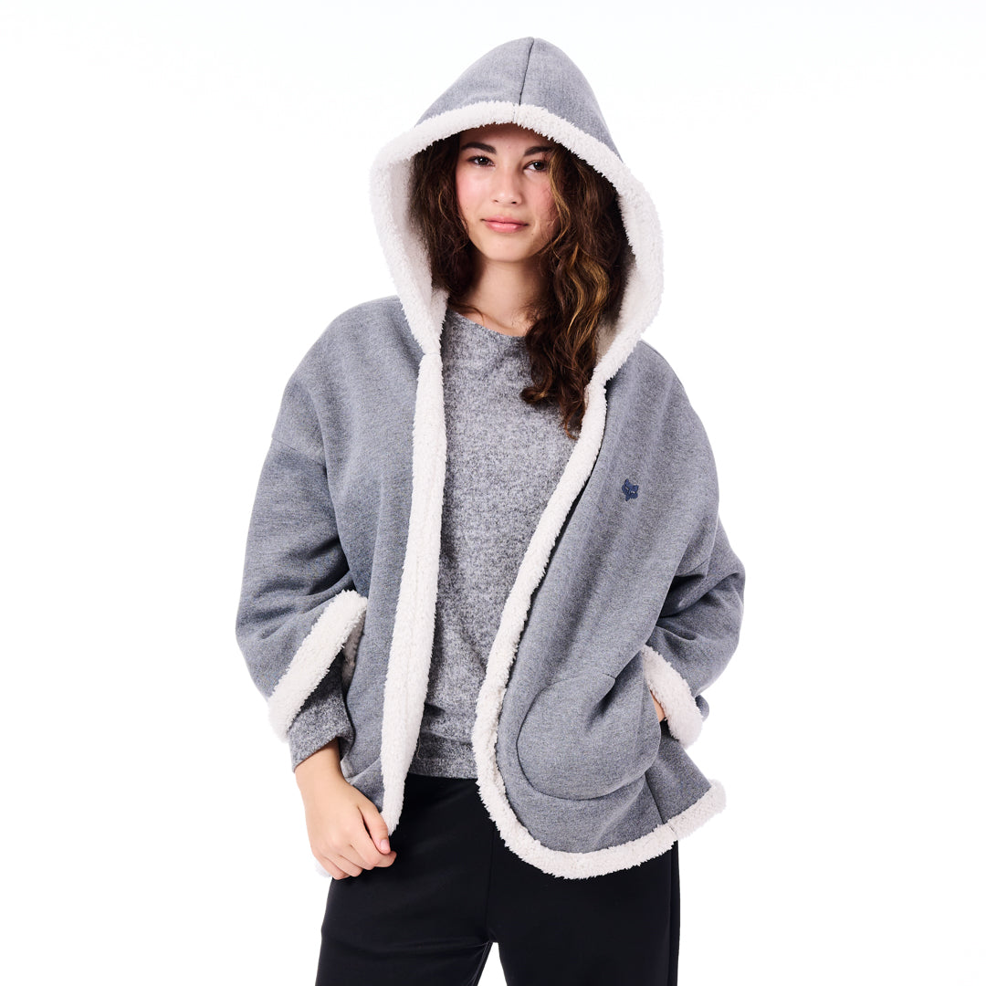 Woman wearing a gray hoodie with white trim on a white background