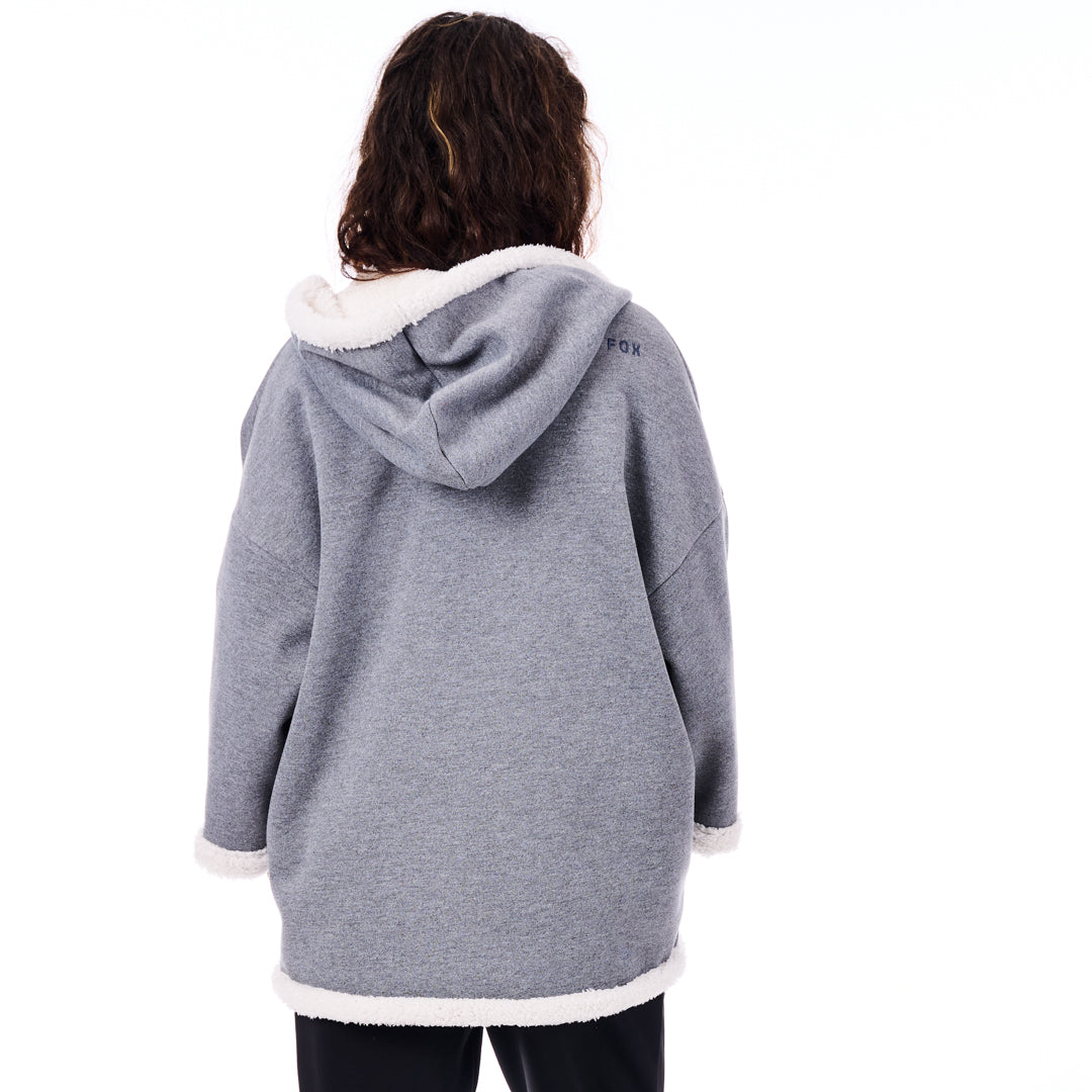 Person wearing a gray hoodie with white trim on a white background