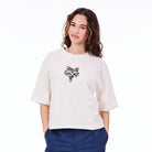 Person wearing a white t-shirt with a black floral design on a white background